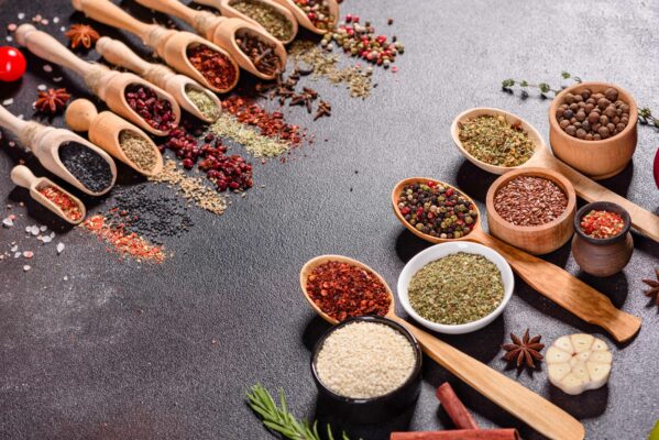 spices and herbs of current flavor trends over dark stone
